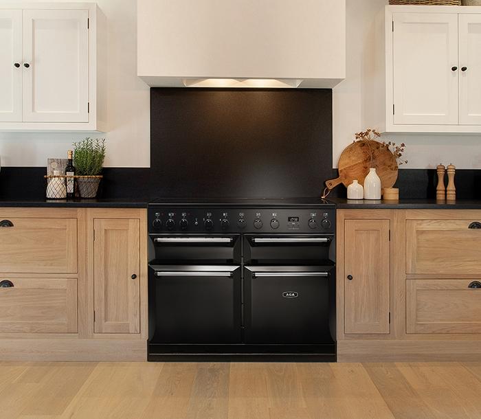 AGA Masterchef Deluxe 110 with induction in Black with wooden cabinetry 