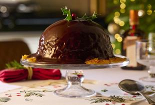Chocolate Orange Pudding with Chocolate Orange Sauce and a holly decoration